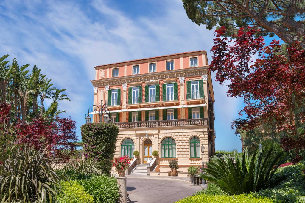 Elegant cliffside luxury hotel in Sorrento with grand Mediterranean architecture, overlooking the Bay of Naples and lush gardens