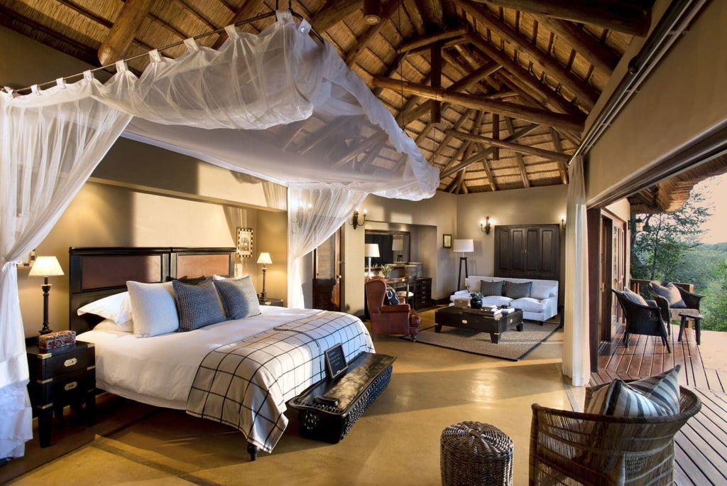 Luxurious safari lodge suite with private plunge pool overlooking Kruger savanna, wooden deck and natural color furnishings