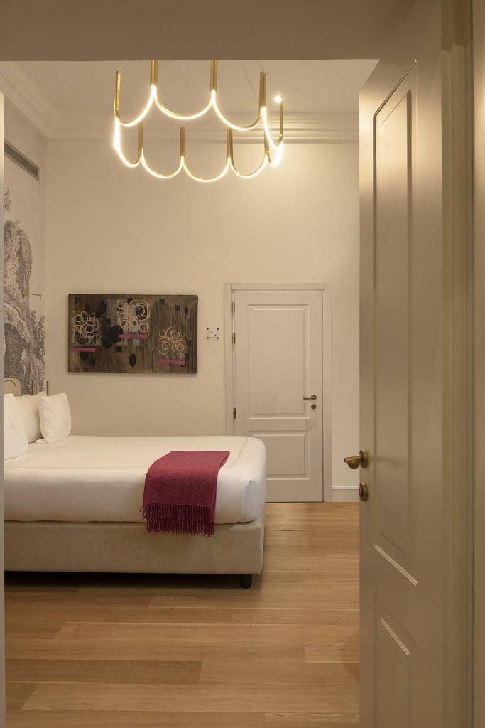 Elegant suite at a luxurious hotel in Rome with panoramic city views, featuring modern design, plush bedding, and sophisticated Italian architectural details