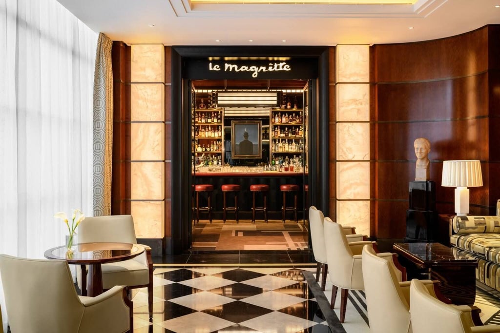 Elegant lobby of [Anonymized] luxury hotel in Mayfair, featuring plush seating, polished marble floors, and sophisticated Art Deco-inspired interior design