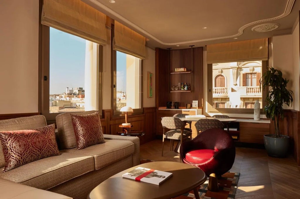 Luxurious grand suite in Spanish hotel, featuring elegant king bed, marble bathroom, panoramic city views, and sophisticated contemporary design with warm neutral tones