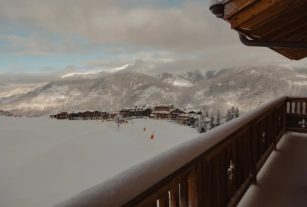 Luxurious alpine chalet-style hotel with snow-covered peaks, warm wooden exteriors, and panoramic mountain views in Courchevel, French Alps