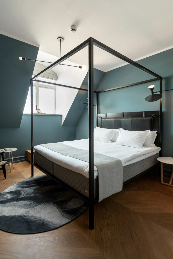 Elegant modern loft room at Scenset Hotel Copenhagen, featuring minimalist Nordic design with clean lines, warm wood tones, and soft natural lighting.