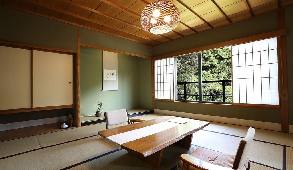 Luxurious Japanese suite with minimalist wooden decor, traditional tatami flooring, soft neutral tones, and a sleek modern shower area