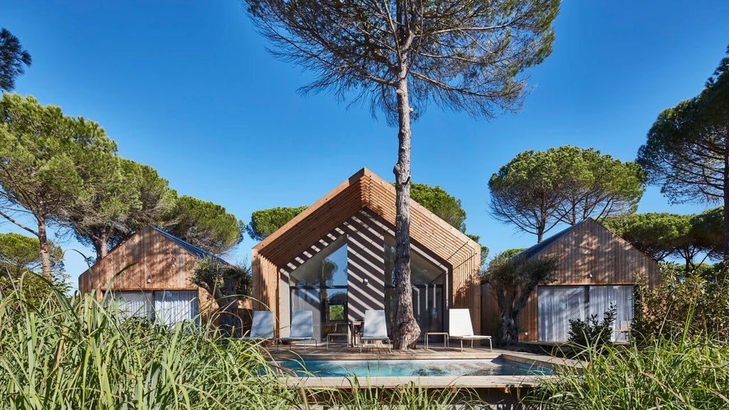 Luxurious bio-pool suite at Sublime Comporta Hotel with minimalist design, natural wood accents, and panoramic view of serene Portuguese landscape