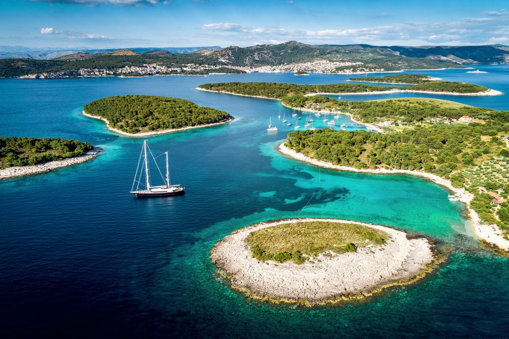 Speedboat cruising across crystal-clear Adriatic waters, connecting historic Split's harbor to luxurious Hvar Island under bright sunlight