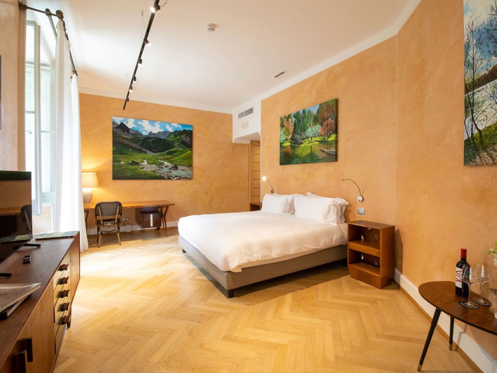 Luxurious deluxe hotel room with modern Italian design, sleek white furnishings, expansive city view, and minimalist artistic decor in Milan