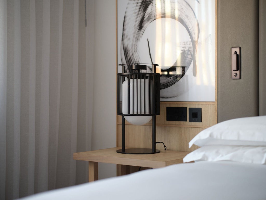 Elegant twin-bed deluxe room at Nobu Hotel London Portman Square with contemporary design, sleek furnishings, and sophisticated neutral color palette