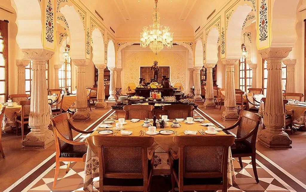 Opulent Oberoi Rajvilas hotel in Jaipur, featuring traditional Rajasthani architecture with ornate domes, arched windows and manicured gardens