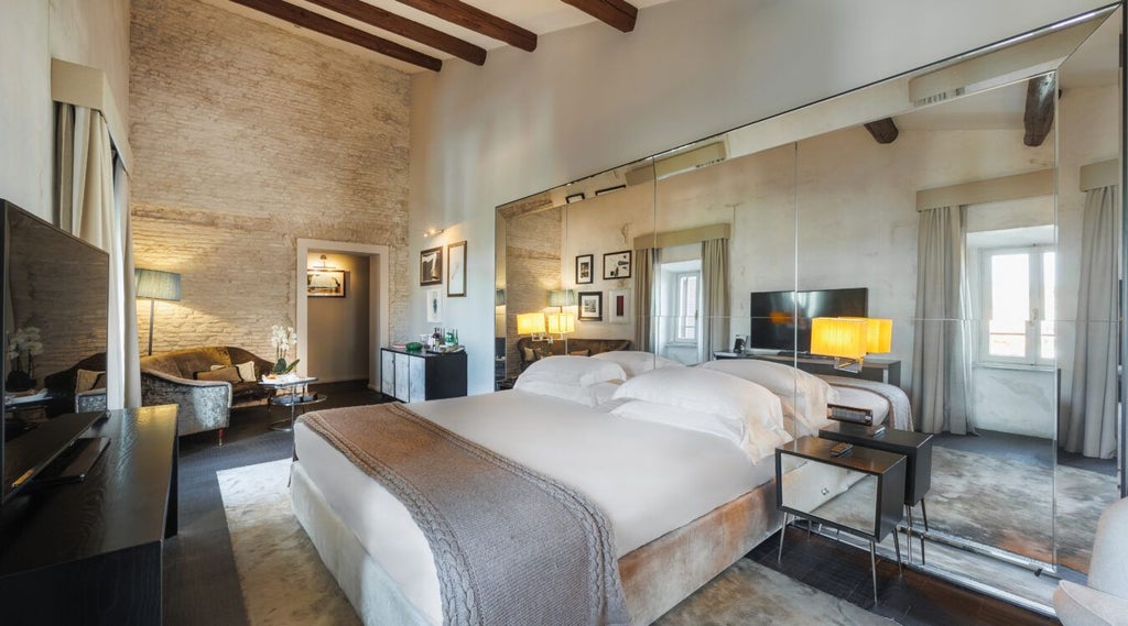 Luxurious D.O.M Suite with elegant Italian design, featuring plush white bedding, marble bathroom, and refined contemporary furnishings in warm neutral tones