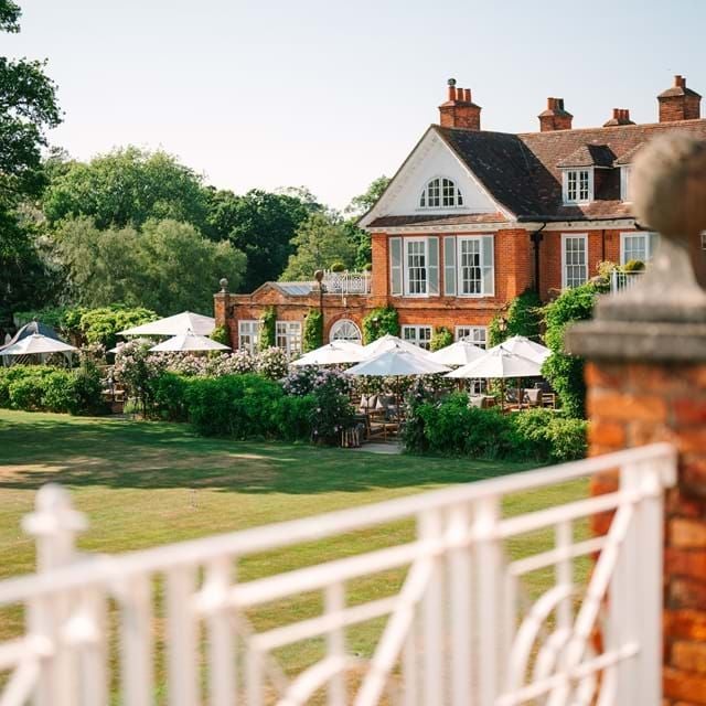 Luxurious countryside hotel nestled in lush New Forest landscape, featuring elegant stone facade, manicured gardens, and sophisticated architectural design.