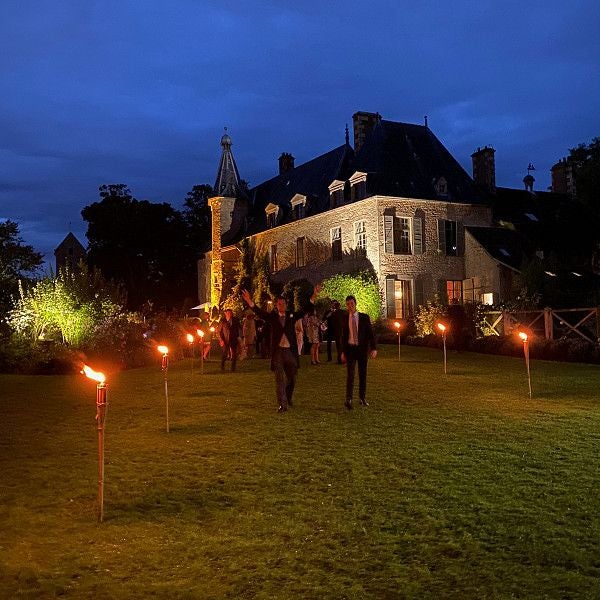 Elegant 17th-century French château hotel with ornate stone facade, manicured gardens, and classic architectural details in the Loire Valley landscape