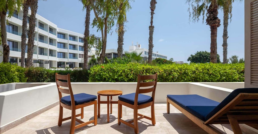 Spacious terrace garden view room at a luxurious Cyprus hotel, featuring elegant decor, modern amenities, and panoramic views of lush landscaped grounds