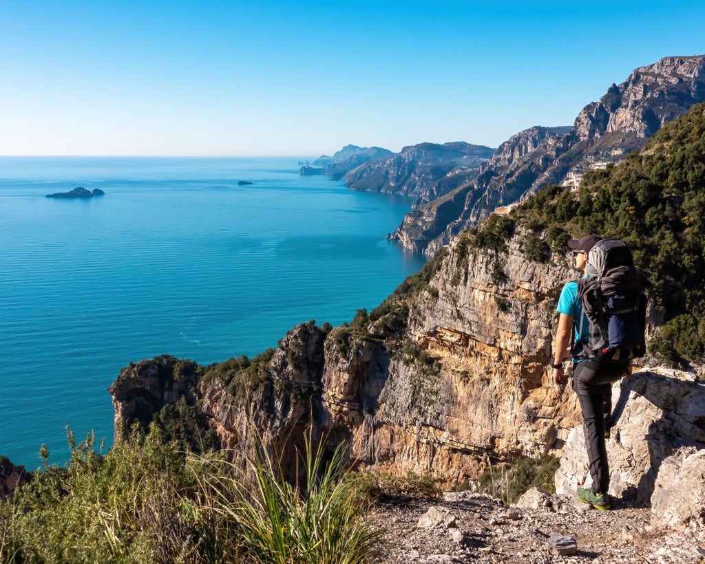 Panoramic coastal trail along Amalfi's dramatic cliffs, with stone pathways winding between mountains and Mediterranean waters below