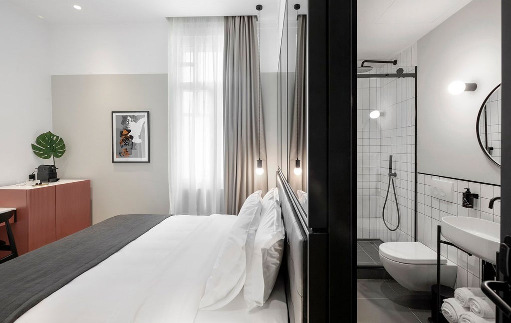 Modern hotel room with minimalist design, gray color palette, sleek queen bed, clean lines, urban view through large window, elegant neutral furnishings in Thessaloniki, Greece