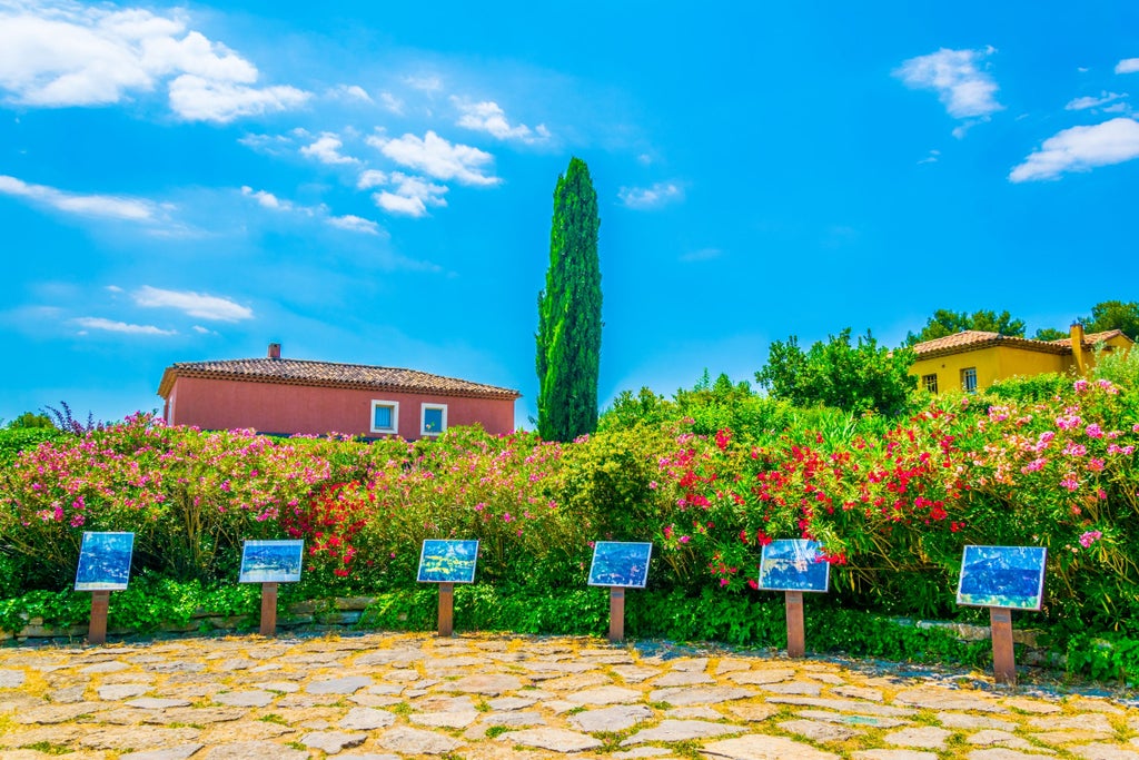 Sunlit Provençal terrace with elegant artists painting colorful canvases, vibrant parasols, and chic easels against backdrop of historic Aix-en-Provence architecture