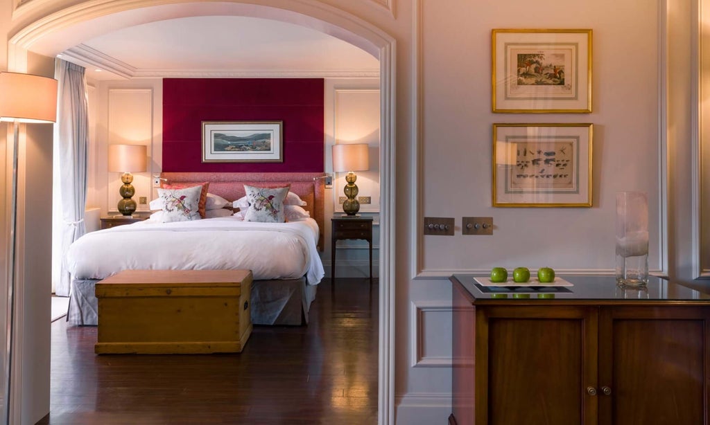 Luxurious junior suite at Chewton Glen Hotel & Spa, featuring elegant decor, plush king bed, floor-to-ceiling windows, and contemporary countryside design in United Kingdom