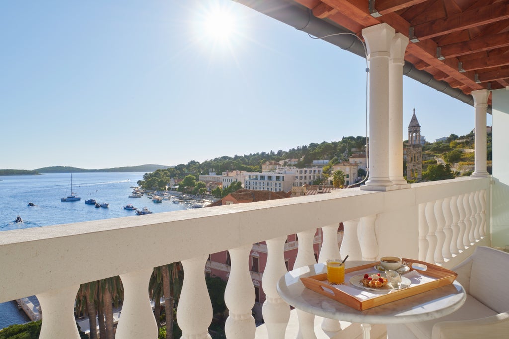 Elegant baroque façade of Palace Elizabeth Hotel featuring ornate stone carvings, arched windows, and a classic Mediterranean style in Hvar