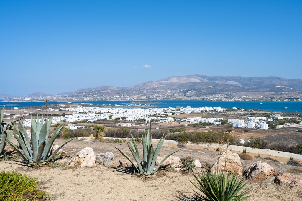 Luxurious white-washed villa perched on Antiparos hillside with infinity pool overlooking the azure Aegean Sea and distant islands