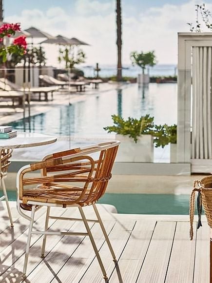 Luxurious junior suite with private plunge pool overlooking Bay area, featuring modern minimalist design and elegant Mediterranean-inspired decor