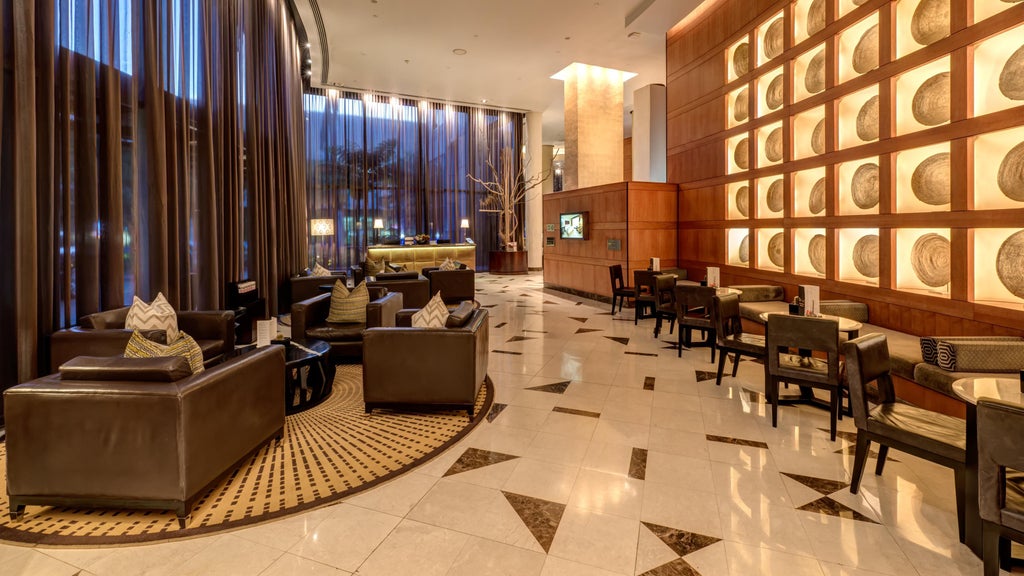 Luxurious airport hotel exterior with glass facade, modern architecture and upscale entrance featuring polished stone finishes