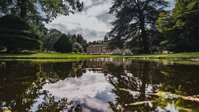 Opulent five-star luxury hotel nestled in lush Yorkshire countryside, featuring elegant Georgian architecture and manicured gardens at scenset Hall