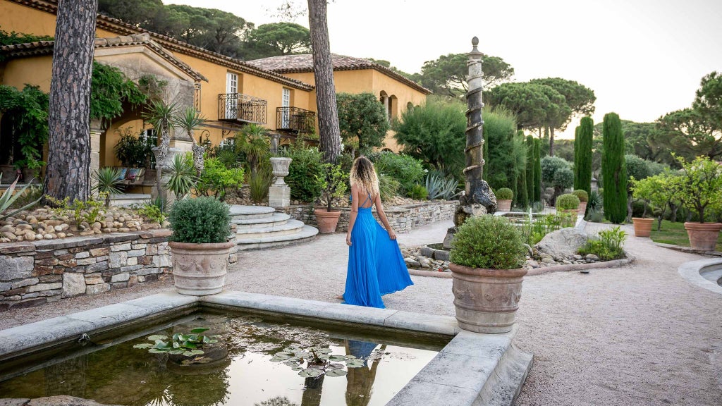 Luxurious white-washed Villa Marie hotel nestled in lush Saint-Tropez gardens with elegant Mediterranean architecture and pristine swimming pool terrace