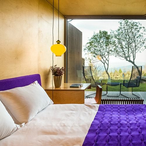 Elegant mountain-view double room with private balcony, featuring crisp white linens, warm wood accents, and panoramic scenery at Casa das Penhas Douradas