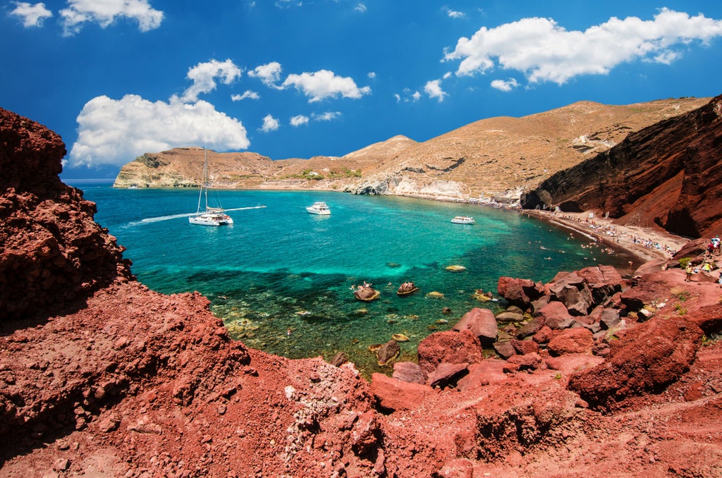 Luxurious private tour overlooking whitewashed Santorini villages, blue-domed churches, and ancient Akrotiri archaeological site with dramatic Aegean Sea backdrop