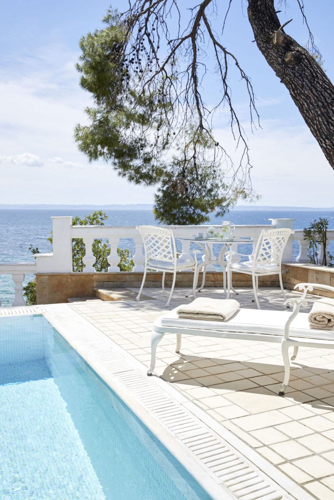 Luxurious executive pool suite at scenset resort with panoramic sea view, private infinity pool, modern minimalist design, and elegant coastal Greek decor