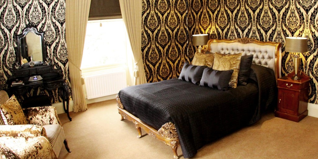 Luxurious hotel room at Crab Manor Hotel with elegant decor, plush furnishings, and a panoramic view of coastal landscape in the United Kingdom.