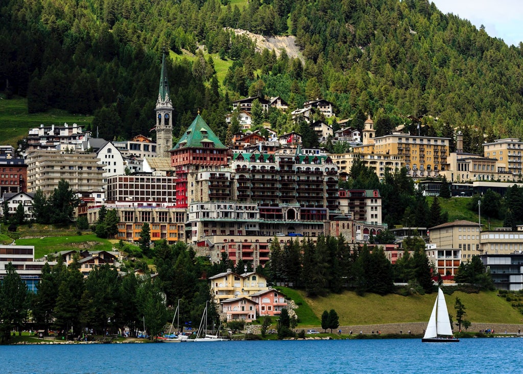 Visitors admiring modern art displays at exclusive St. Moritz gallery, surrounded by snow-capped Alpine peaks and luxury boutiques