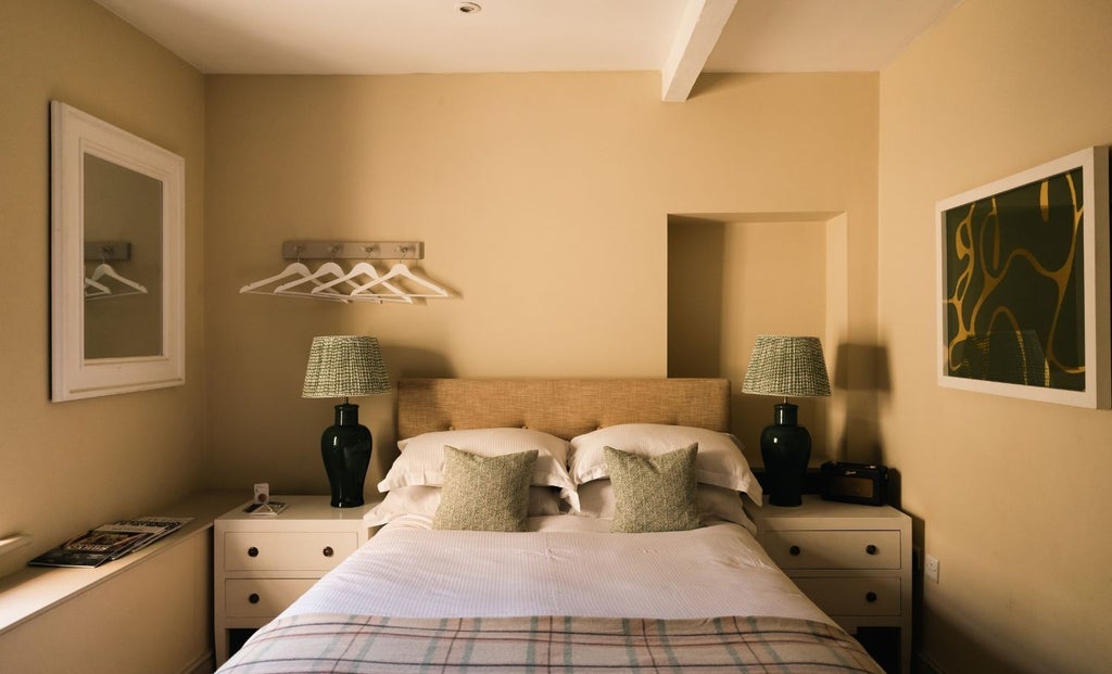 Elegant small double room at The Scenset Arms hotel, featuring crisp white linens, rustic wooden headboard, and soft ambient lighting in a cozy UK setting.