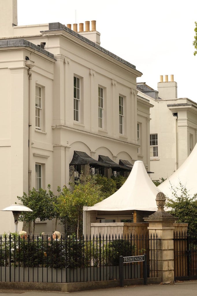 Elegant boutique hotel exterior with Georgian architecture, soft warm lighting, and classic stone facade in a charming UK cityscape at dusk