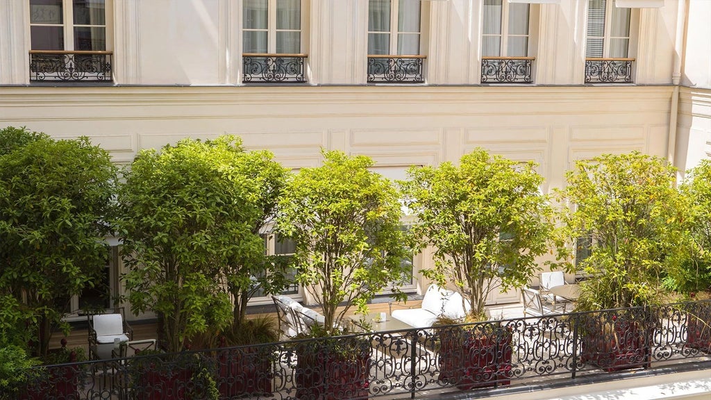 Elegant junior suite at La Réserve Paris Hotel & Spa with private terrace, featuring sophisticated decor and panoramic city views of the French capital