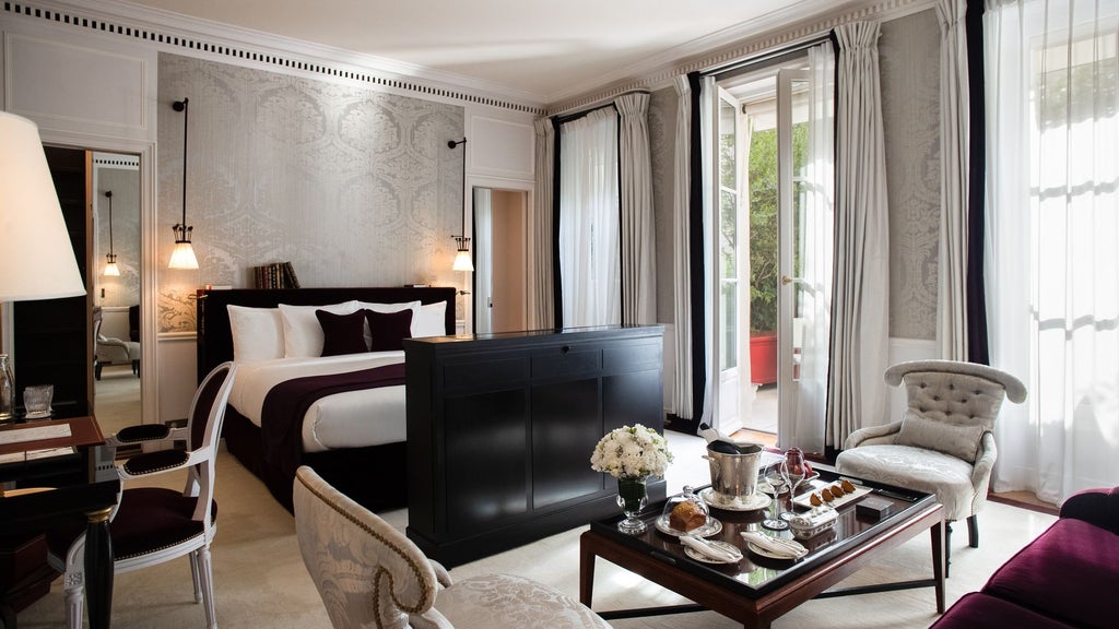 Elegant Parisian junior suite with private terrace, featuring luxurious contemporary decor, soft neutral tones, and panoramic city views at La Réserve Hotel & Spa