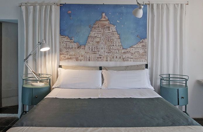 Elegant boutique hotel room with rustic stone walls, minimalist wooden furnishings, and soft natural light in a charming Italian countryside setting