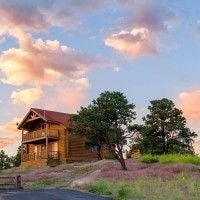 Cozy wooden cabin interior with rustic decor, two bedrooms, warm earth tones, panoramic mountain views, and elegant southwest-inspired furnishings at Zion Mountain Ranch