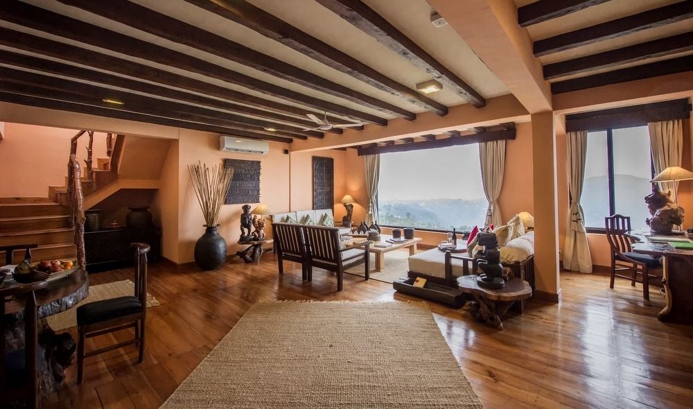 Luxurious mountain resort with traditional Nepalese architecture nestled in Himalayan foothills, featuring ornate wooden details and panoramic views