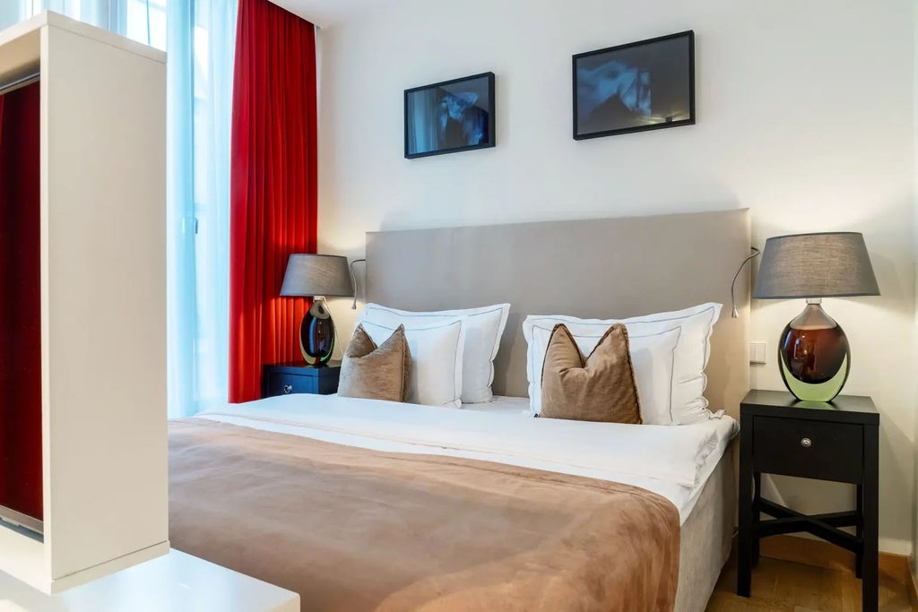 Elegant superior hotel room at Berns Hotel in Stockholm, featuring plush white bedding, modern minimalist decor, and soft neutral color palette with large windows