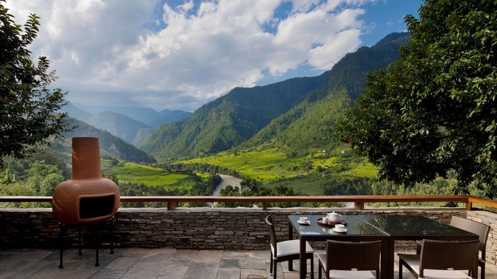 Spacious COMO Villa interior with traditional Bhutanese design, warm wood accents, panoramic mountain views, and elegant minimalist luxury furnishings