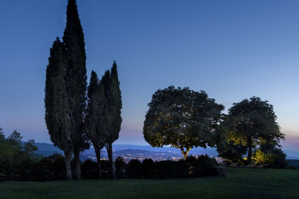 Rustic stone villa nestled in Tuscan countryside, with rolling green hills, cypress trees, and golden sunlight illuminating elegant historic architecture