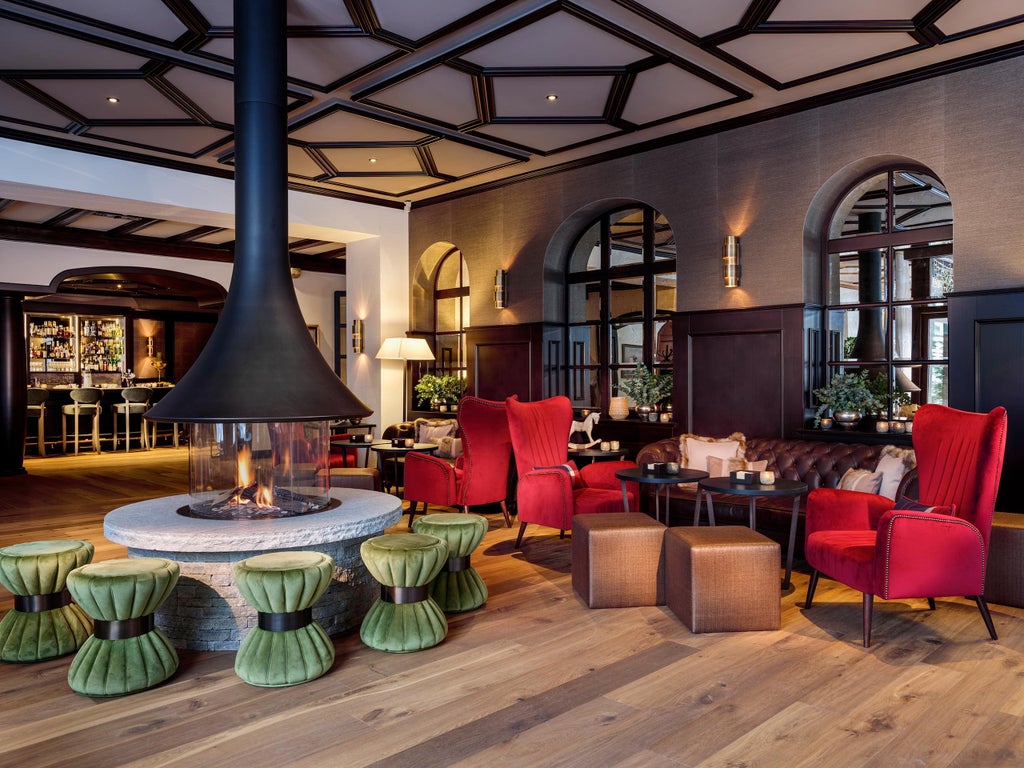 Grand historic Alpine hotel Mont Cervin Palace with snow-capped Matterhorn peak rising behind, traditional Swiss architecture, luxury balconies