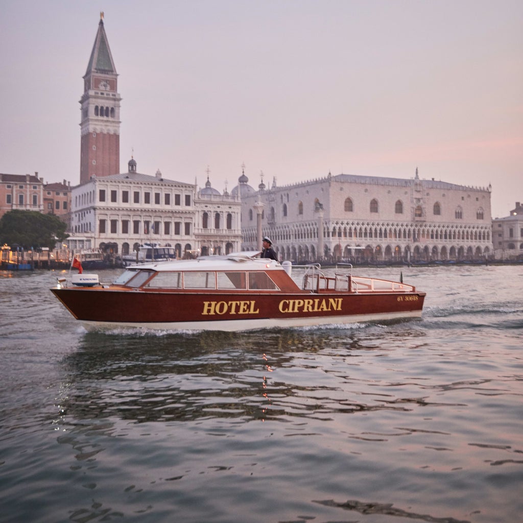 Elegant pool overlooking Venice's lagoon at Belmond Cipriani, with marble columns, manicured gardens and classic Italian architecture