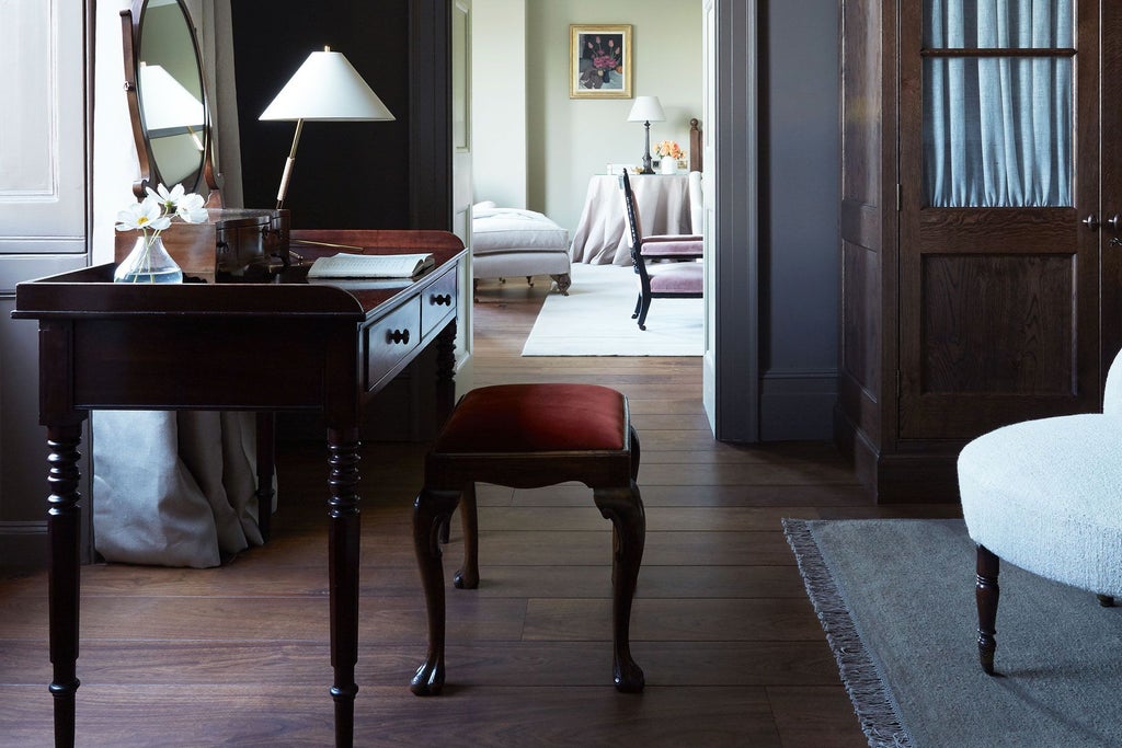 Luxurious woodland-inspired hotel room at Heckfield Place with natural wood tones, soft textiles, and elegant minimalist design in soft earth colors