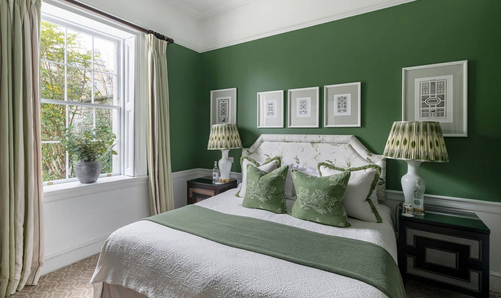 Elegant cream-colored deluxe suite with ornate period furnishings, large sash windows, plush king bed, and classic Georgian architectural details in Bath's Royal Crescent