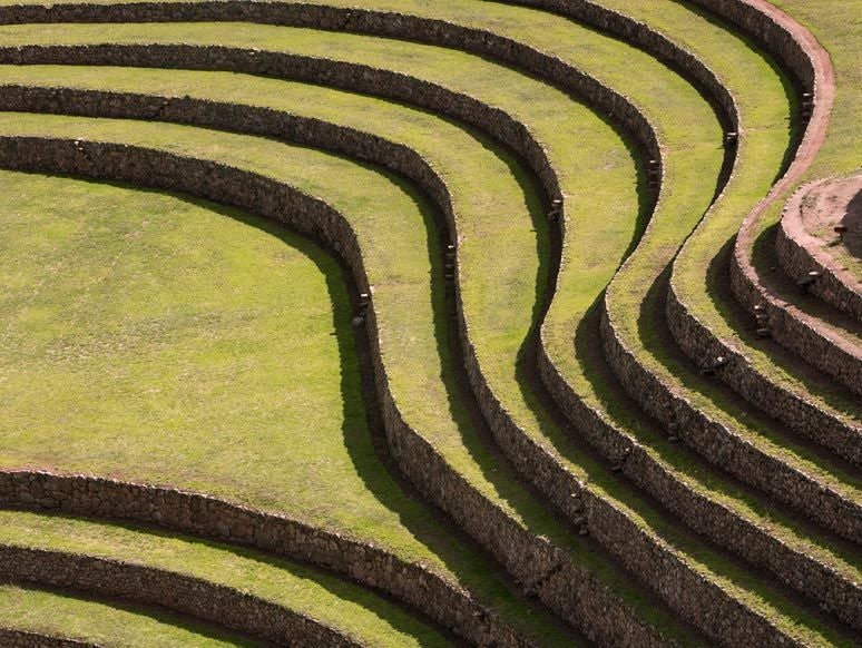 Luxurious hotel nestled in Peru's Sacred Valley, featuring modern architecture blending with dramatic Andean mountain landscape and verdant surroundings