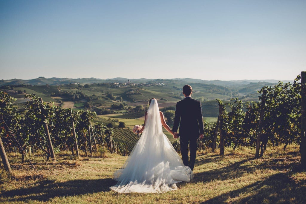 Luxurious poolside terrace of a scenic Italian villa hotel, overlooking rolling Tuscan hills with elegant lounge chairs and pristine turquoise swimming pool