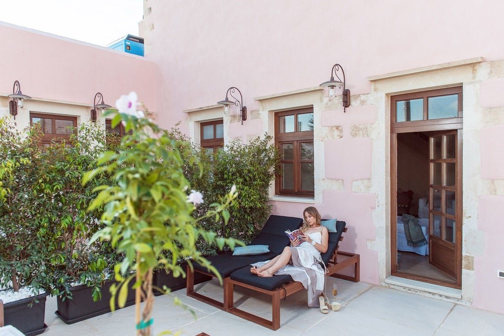 Elegant superior suite with private terrace overlooking Grecian landscape, featuring modern minimalist decor and soft neutral color palette in boutique hotel setting