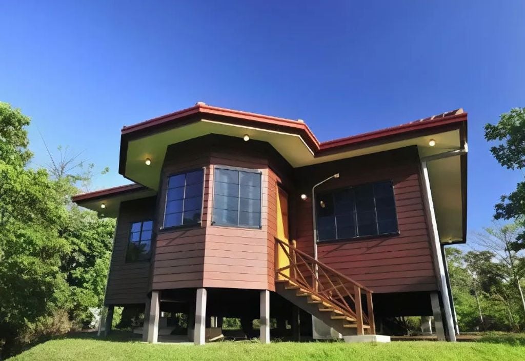 Modern luxury bungalows nestled in lush tropical forest, connected by wooden walkways, with private balconies overlooking dense jungle canopy